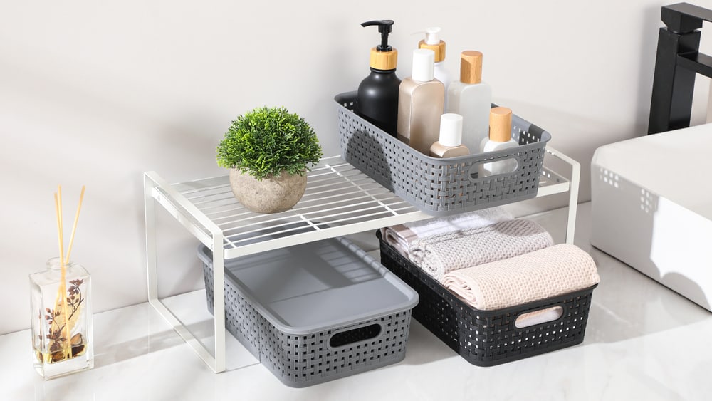 Woven storage baskets lined up on a shelf tier